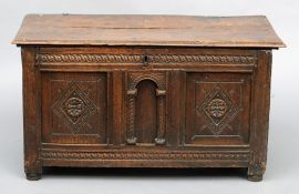 An 18th century carved oak panel coffer The hinged moulded rectangular lid above a carved three