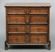 An 18th century oak chest of drawers The moulded rectangular top above four long geometrically