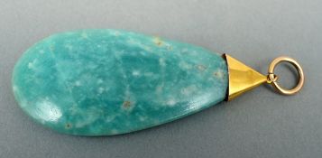 A 9 ct gold mounted jade pendant 5.75 cms high.Some slight fritting, slight dent to gold mount.