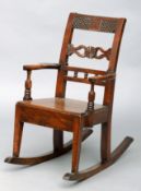 A 19th century East Anglian mahogany child’s rocking chair The carved top rail above a shaped carved