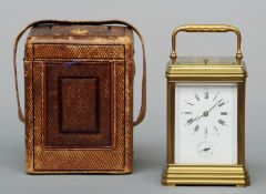 A 19th century brass cased striking carriage alarm clock The enamelled dial with Roman and Arabic