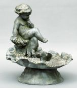 A 19th century style lead bird bath Of scalloped shell form, mounted with a putto and a bird,