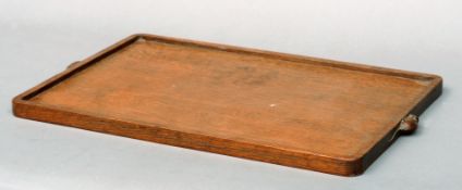 A Robert “Mouseman” Thompson azed oak tray Of rectangular form with plain gallery and mounted with