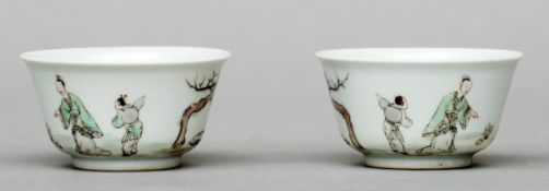 A pair of Chinse porcelain tea bowls Each decorated with figures and a goat beside a tree, the bases