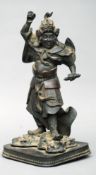A Japanese Meiji period patinated bronze figure of a Samurai Modelled holding a scroll and