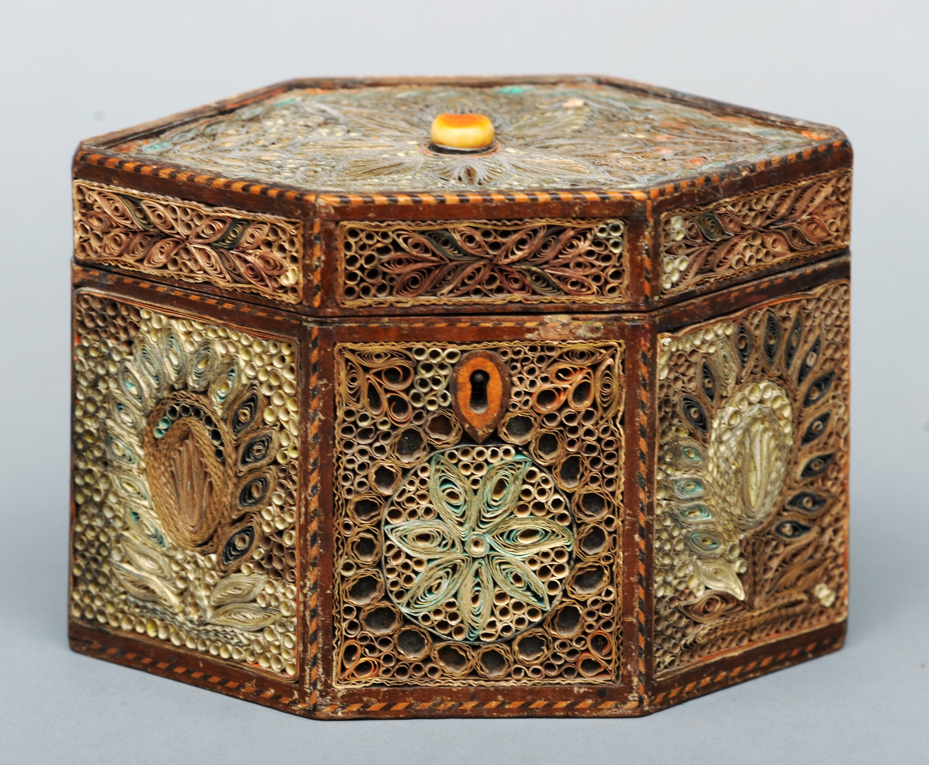 An 18th century scroll work tea caddy The hexagonal box with a hinged lid and decorated allover with