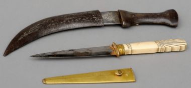 A 19th century carved ivory handled and gilded dagger Housed in a gilded sheath. 25.5 cms long.