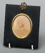 A 19th century portrait miniature on card of Captain Marriott In ebonised frame with acorn cast