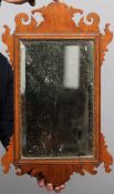 An 18th century walnut fret carved mirror 64 cms high.Overall good, some wear and tear, some