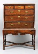 An 18th century oak chest on stand The moulded rectangular top above an arrangement of three short