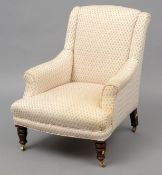 A Victorian upholstered nursing chair The padded arms above an overstuffed seat, standing on