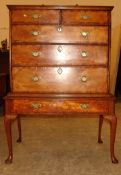 An 18th century walnut and elm chest on stand The moulded rectangular top above an arrangement of