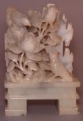 A Chinese soapstone carving Modelled as birds amongst floral sprays. 13 cms high.Generally in good