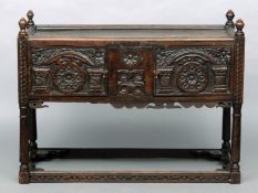 An 18th century and later carved oak side cabinet The finial mounted moulded top rail above twin