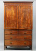 A 19th century mahogany linen press The moulded cornice above twin panelled doors over two short