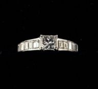 An 18 ct white gold and diamond ring The central princess cut stone flanked by ten baguette cut