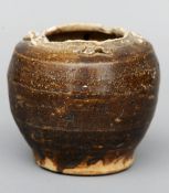 A Tang Dynasty brown glazed storage pot 15 cms high.Damage to top rim, damage to small loop