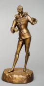 An early 20th century French patinated bronze figure of a harlequin, after Maseree Modelled standing