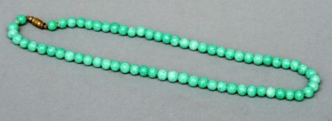 A jade bead necklace 41 cms long.Overall good.