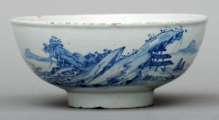 An 18th century Delft bowl Decorated in blue and white with landscape scenes. 19.5 cms diameter.Some