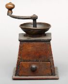 A late 19th century metal mounted walnut coffee grinder Of typical construction, fitted with drawer.