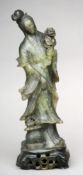 A Chinese nephrite jade carving of Guanyin Modelled in flowing robes holding a floral spray standing