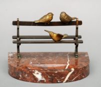 A late 19th/early 20th century bronze mounted rouge marble desk weight Modelled as three birds