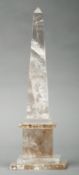 A decorative rock crystal type obelisk Of typical form, on a stepped plinth base. 25.5 cms high.