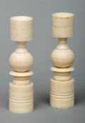 A pair of early 20th century carved ivory candlesticks Each of cylindrical and ball turned form.