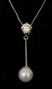 A pearl and diamond set pendant The single claw set diamond above the single suspended pear drop,