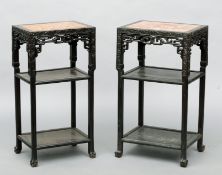 A near pair of late 19th/early 20th century Chinese hardwood three tier side tables Each with a