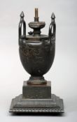 A 19th century classical revival patinated bronze table lamp The urn form body with incised