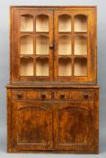 A 19th century painted pine dresser The twin glazed doors above two drawers, with allover grained