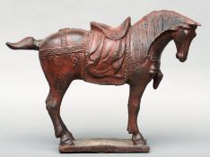 A cast iron model of a Tang horse Naturalistically modelled with allover red patination. 46 cms
