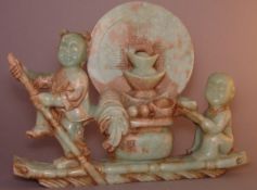 A Chinese hardstone carving Modelled as two children on a raft transporting precious objects,