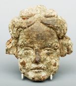 An 17th century carved limewood and painted cherub mask Typically modelled. 20 cms high.Generally in