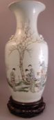 A late 19th/early 20th century Chinese porcelain vaseDecorated with female figures in a garden