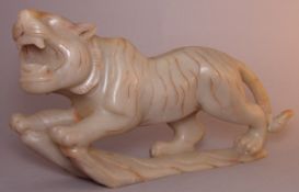 A Chinese hardstone carving of a tiger Naturalistically modelled. 16 cms high.Generally in good