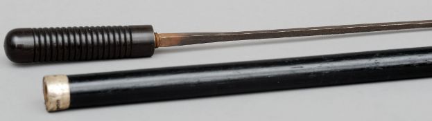 A carved lignum vitae handled sword stick The ebonised shaft mounted with a silver collar. 89 cms