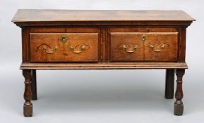 An 18th century oak low dresser The rounded rectangular top above a deep frieze with two drawers