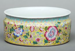 A Cantonese enamel decorated porcelain jardiniere bowl The yellow ground decorated with blossoming