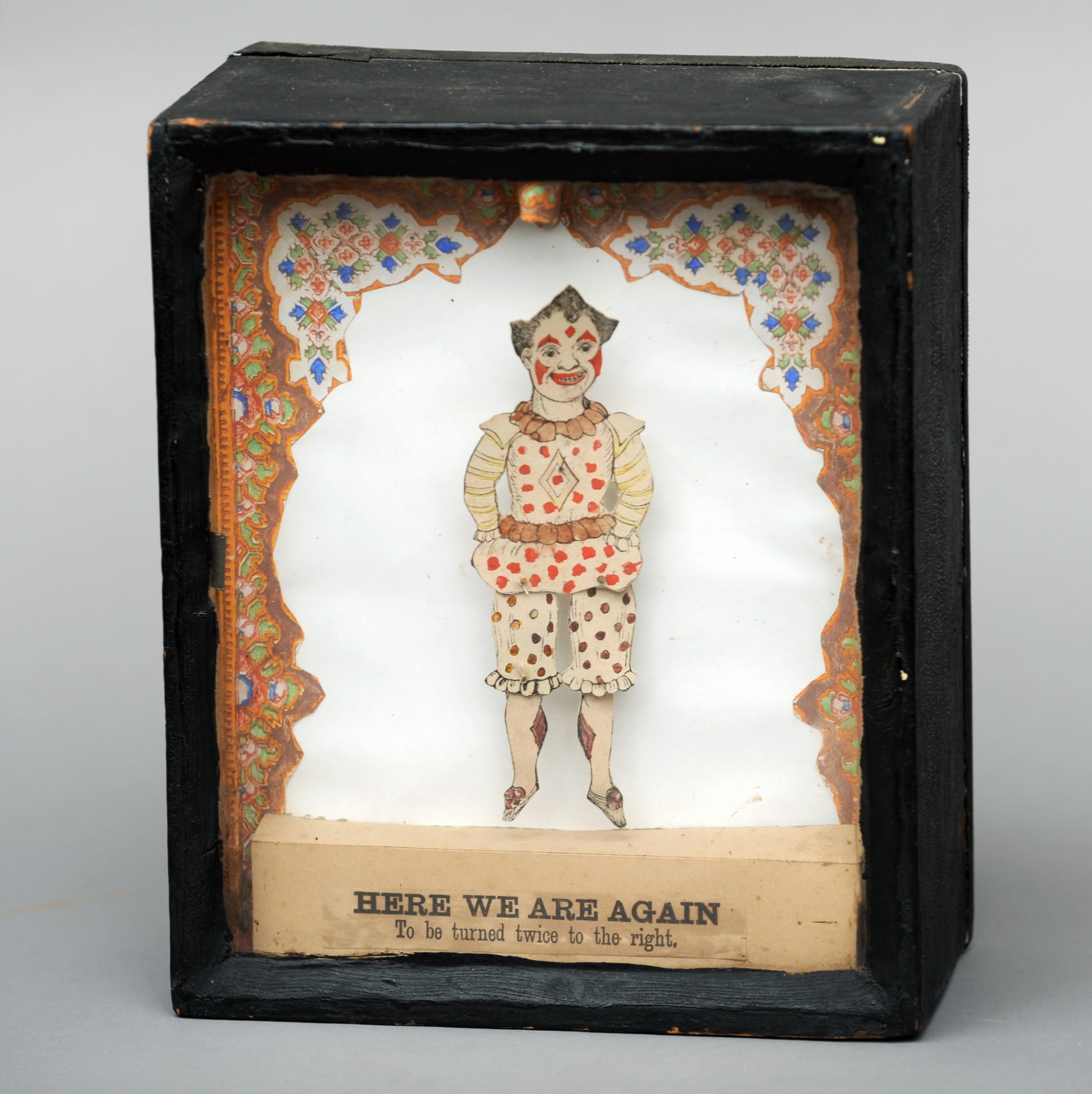 A late 19th century sand box automaton The central coloured figure modelled as a clown above the