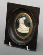 A late 18th/early 19th century memento mori miniature Moulded as a young woman kneeling with a