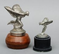 A white metal Spirit of Ecstasy car mascot Kneeling version, mounted on a wooden plinth base;