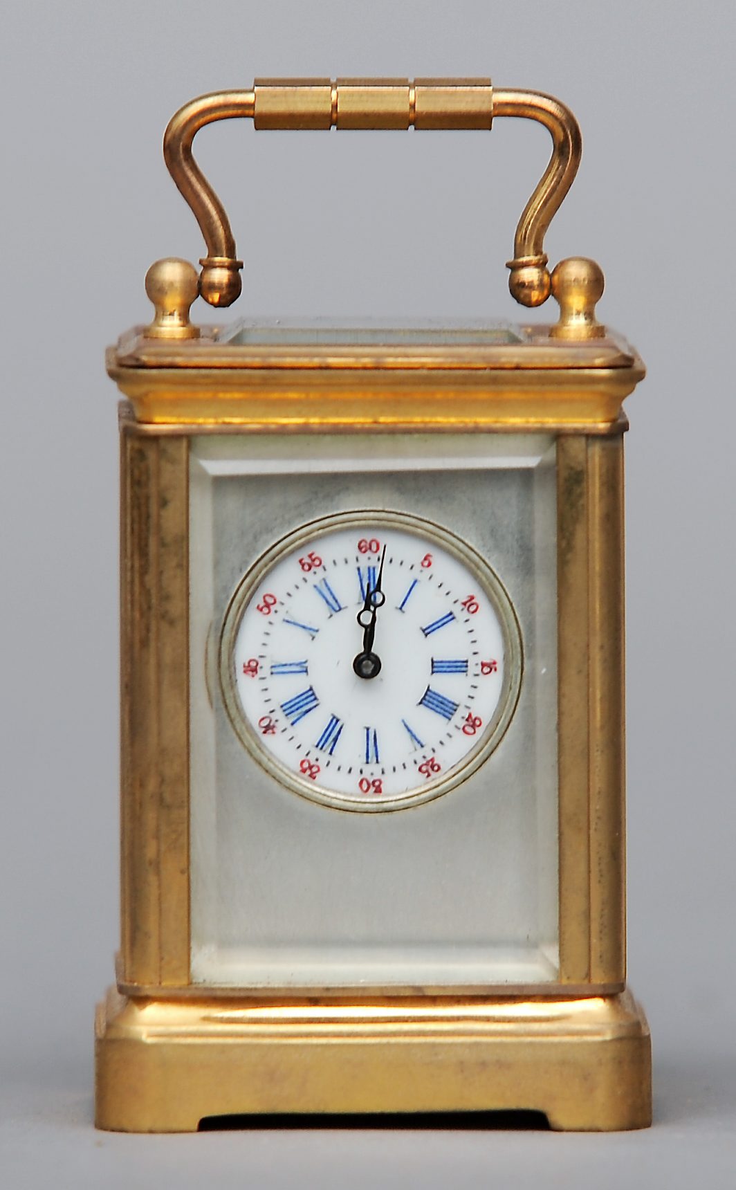 A miniature brass cased carriage clock The white enamelled dial with Roman numerals and Arabic