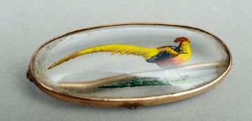 A 9 ct gold mounted reverse carved brooch Decorated to the centre with a painted pheasant. 4.5 cms