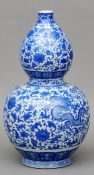 A Chinese blue and white porcelain double gourd vase Decorated overall with dragons within lotus