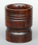 An 18th century turned lignum vitae mortar With ring turned decoration. 16 cms high.Generally in