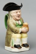 A 19th century Staffordshire toby jug The seated figure modelled wearing a tricorn hat and holding