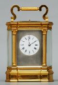 A 19th century repeating carriage clock The white enamelled dial with Roman numerals and Arabic